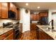 Kitchen featuring an island with granite countertop, stainless steel appliances and wood cabinets at 17507 W Fetlock Trl, Surprise, AZ 85387