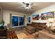 Bright and airy living room with wood floors, plush seating and patio access at 17507 W Fetlock Trl, Surprise, AZ 85387