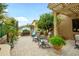 Back patio featuring a pergola, seating area, mature citrus trees, and desert landscaping at 17553 N Thornberry Dr, Surprise, AZ 85374