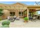 Inviting back patio featuring a pergola and covered area, and a comfortable outdoor seating area at 17553 N Thornberry Dr, Surprise, AZ 85374