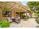 Inviting back patio featuring a pergola and covered area, and a comfortable outdoor seating area at 17553 N Thornberry Dr, Surprise, AZ 85374