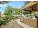 Serene backyard with a rock water feature, desert landscaping and an outdoor kitchen at 17553 N Thornberry Dr, Surprise, AZ 85374