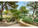 Lush landscaping, rock water feature, and desert foliage create a relaxing backyard oasis at 17553 N Thornberry Dr, Surprise, AZ 85374