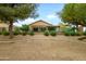 View of the backyard with mature landscaping, an upper patio, and a perimeter fence at 17553 N Thornberry Dr, Surprise, AZ 85374