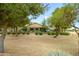 View of the backyard with mature landscaping, an upper patio, and a perimeter fence at 17553 N Thornberry Dr, Surprise, AZ 85374