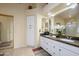 Elegant bathroom featuring dual sinks, a beautiful granite countertop, and ample storage at 17553 N Thornberry Dr, Surprise, AZ 85374