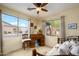 Sun-filled bedroom featuring two windows, a roll-top desk, and a cozy daybed at 17553 N Thornberry Dr, Surprise, AZ 85374