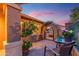 Private courtyard featuring an arched entry, a table with chairs, and lush potted plants at 17553 N Thornberry Dr, Surprise, AZ 85374