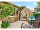 Quaint outdoor courtyard with a decorative entry gate and a small lemon tree at 17553 N Thornberry Dr, Surprise, AZ 85374