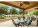 A beautifully furnished covered patio with views of the golf course beyond at 17553 N Thornberry Dr, Surprise, AZ 85374