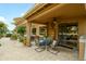 A cozy covered patio features a dining table and comfortable seating for outdoor enjoyment at 17553 N Thornberry Dr, Surprise, AZ 85374