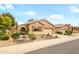 Charming single-story home with mature landscaping and a decorative entry gate at 17553 N Thornberry Dr, Surprise, AZ 85374