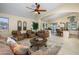 Open concept living room featuring tile floors, arched doorways, and an adjacent kitchen at 17553 N Thornberry Dr, Surprise, AZ 85374