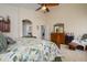 Bright main bedroom featuring neutral tones, a ceiling fan, tile floors, and furniture at 17553 N Thornberry Dr, Surprise, AZ 85374