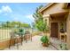 Covered back patio with neutral pavers, outdoor seating, and a view of the community at 17553 N Thornberry Dr, Surprise, AZ 85374