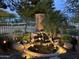 Picturesque backyard water feature with stone accents and lush greenery; the fountain adds a serene touch at 17553 N Thornberry Dr, Surprise, AZ 85374