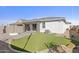 Backyard with a paver patio, fire pit, artificial turf, and the home's exterior with stone accents at 17819 W Mission Ln, Waddell, AZ 85355