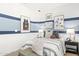 Stylish bedroom featuring blue accent wall stripes and decor with basketball themed artwork at 17819 W Mission Ln, Waddell, AZ 85355