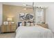 Comfortable main bedroom featuring stylish decor, a modern light fixture and lots of natural light at 17819 W Mission Ln, Waddell, AZ 85355