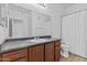 A clean bathroom features wood cabinets, a large mirror, and a shower with a curtain at 1941 S Pierpont Dr # 1013, Mesa, AZ 85206