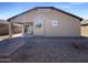 Rear exterior with a covered patio and low-maintenance gravel landscaping at 20033 N Herbert Ave, Maricopa, AZ 85138