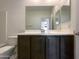 Bathroom featuring a dark wood single sink vanity with a wide mirror and tile flooring at 20033 N Herbert Ave, Maricopa, AZ 85138