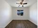 Bright bedroom with ceiling fan and vinyl floors, offering ample natural light at 20033 N Herbert Ave, Maricopa, AZ 85138