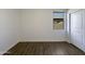 Clean bedroom with luxury vinyl plank flooring, natural light, and large white closet at 20033 N Herbert Ave, Maricopa, AZ 85138