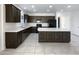 Modern kitchen with dark wood cabinets, stainless steel appliances, and an island at 20033 N Herbert Ave, Maricopa, AZ 85138