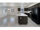 Well-lit eat-in kitchen features a center island, stainless steel appliances, and dark wood cabinetry at 20033 N Herbert Ave, Maricopa, AZ 85138