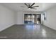 Spacious living area with tile flooring and sliding doors to the backyard at 20033 N Herbert Ave, Maricopa, AZ 85138