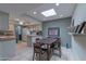 Open floor plan with a dining area featuring a skylight and a view of the kitchen at 2212 W Claremont St, Phoenix, AZ 85015