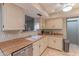 Well-lit kitchen featuring white cabinets, stainless steel appliances, and ample counter space at 2212 W Claremont St, Phoenix, AZ 85015