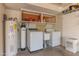 The laundry room has a washer, dryer, water heater, utility sink and storage at 2212 W Claremont St, Phoenix, AZ 85015