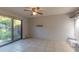 The empty room has tile floors, a sliding glass door to the exterior, and modern lighting at 2212 W Claremont St, Phoenix, AZ 85015