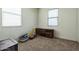 Bedroom with neutral carpet, two windows, and a wooden dresser at 23689 W Watkins St, Buckeye, AZ 85326