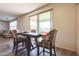 Dining area featuring a wood table and upholstered chairs near sliding glass doors with views of the landscape at 23689 W Watkins St, Buckeye, AZ 85326