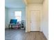 Entryway with light-colored wood flooring, a white front door, and a bench with fitness equipment at 23689 W Watkins St, Buckeye, AZ 85326