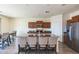 Modern kitchen featuring a large island with seating, stainless steel appliances, and wood-look flooring at 23689 W Watkins St, Buckeye, AZ 85326