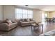 Bright living room with hardwood floors, neutral furniture, and a large window offering natural light at 23689 W Watkins St, Buckeye, AZ 85326