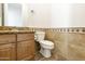 Bathroom featuring tile flooring and backsplash, toilet, and granite counter at 2428 E Iris Dr, Chandler, AZ 85286