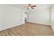 A bright bedroom features wood-look floors, a ceiling fan, and plantation shutters at 2428 E Iris Dr, Chandler, AZ 85286