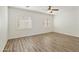 Spacious bedroom featuring hardwood floors, plantation shutters and ceiling fan at 2428 E Iris Dr, Chandler, AZ 85286