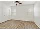 Bright bedroom with white walls, wood-look flooring, and plantation shutters at 2428 E Iris Dr, Chandler, AZ 85286