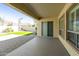 A tranquil covered patio with brick flooring leads to a lush backyard at 2428 E Iris Dr, Chandler, AZ 85286