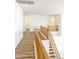 Upstairs hallway with wood flooring and wood railing overlooking entry at 2428 E Iris Dr, Chandler, AZ 85286