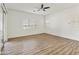 Bright living room with wood flooring, a ceiling fan, and sliding door to the outdoors at 2428 E Iris Dr, Chandler, AZ 85286