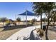 A colorful playground sits under a blue shade canopy, accessible by concrete walkway at 2428 E Iris Dr, Chandler, AZ 85286