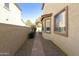 Narrow side yard with a brick-paved path and view of the home's exterior at 2428 E Iris Dr, Chandler, AZ 85286