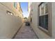 Paved side yard with partial view of the home's exterior at 2428 E Iris Dr, Chandler, AZ 85286